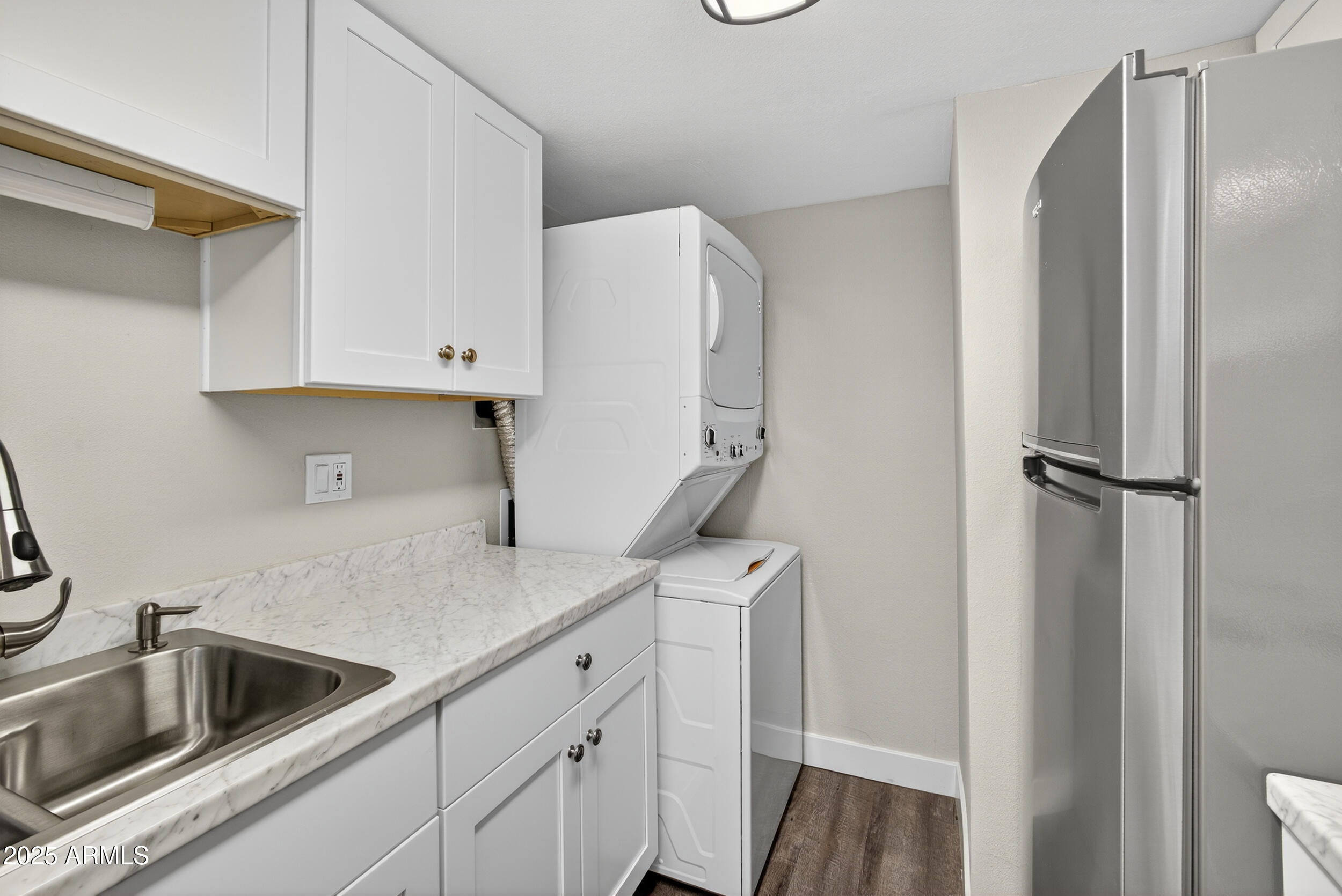 860 East Brown Road, Unit 66 Mesa, AZ 85203 - Photo 9 of 30 a kitchen with a refrigerator sink and cabinets