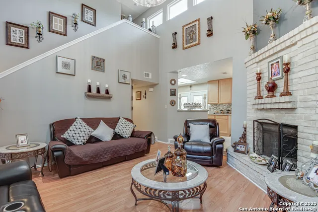 a living room with furniture kitchen view and a fireplace