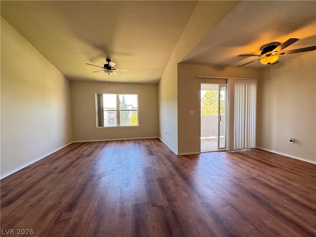 7255 West Sunset Road, Unit 2111 Las Vegas, NV 89113 - Photo 9 of 33 Hardwood-style flooring extends across this generous living area with balcony access.