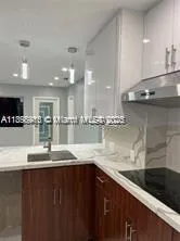 a kitchen with granite countertop a sink and a stove top oven