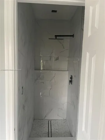 a bathroom with a glass shower door