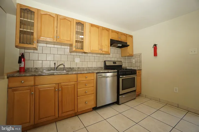 a kitchen with granite countertop cabinets stainless steel appliances and a sink