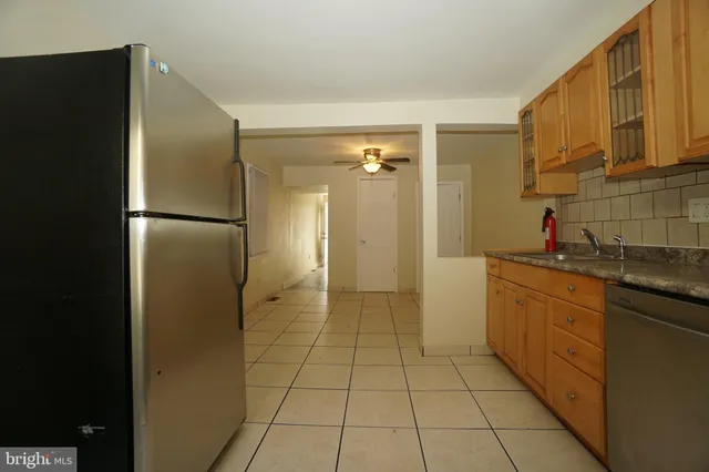 a kitchen with a refrigerator a sink and cabinets