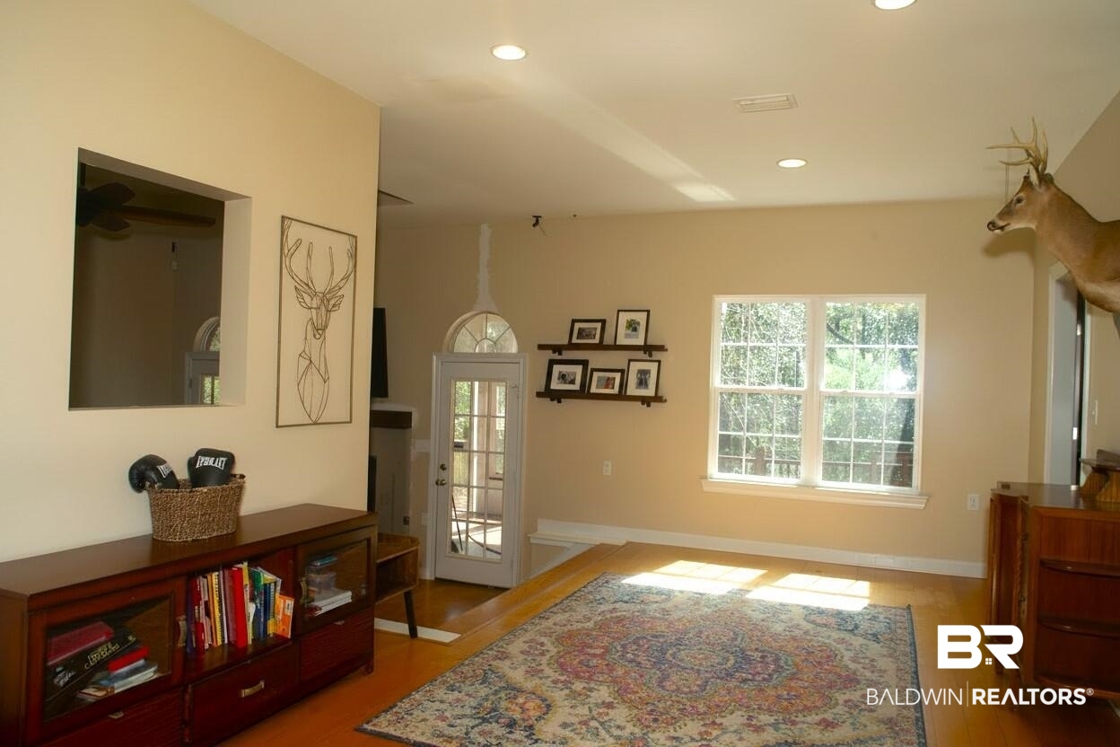 8008 Patricks Landing Road Bay Minette, AL 36507 - Photo 11 of 33 Open concept living area featuring wood-finish flooring, recessed lighting, and a large double window with grid panes