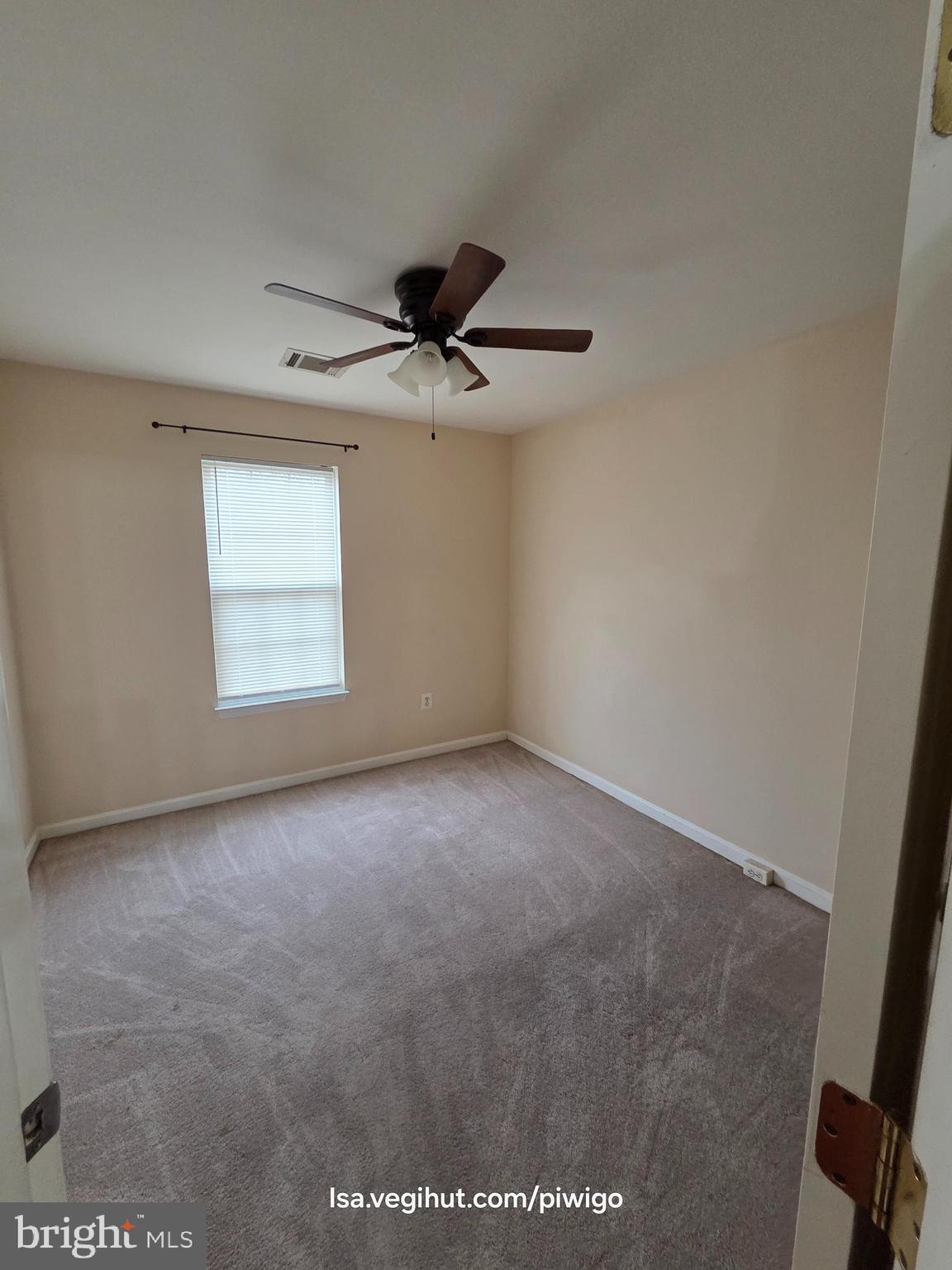 42856 Golf View Drive Chantilly, VA 20152 - Photo 16 of 23 an empty room with a ceiling fan and a window