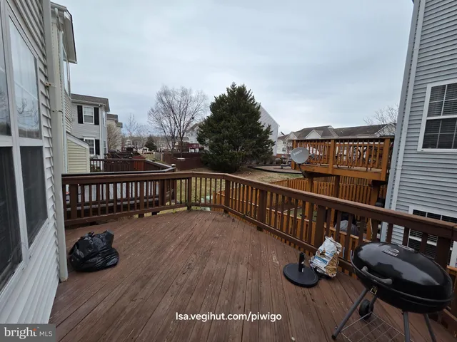 a view of a balcony with chairs and wooden floor