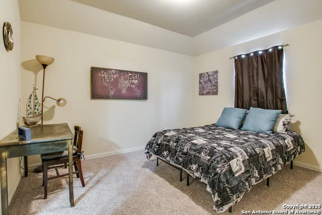 a bedroom with a bed and a table in it