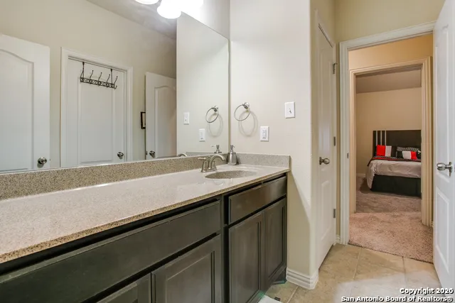 a en suite bathroom with a sink and a mirror