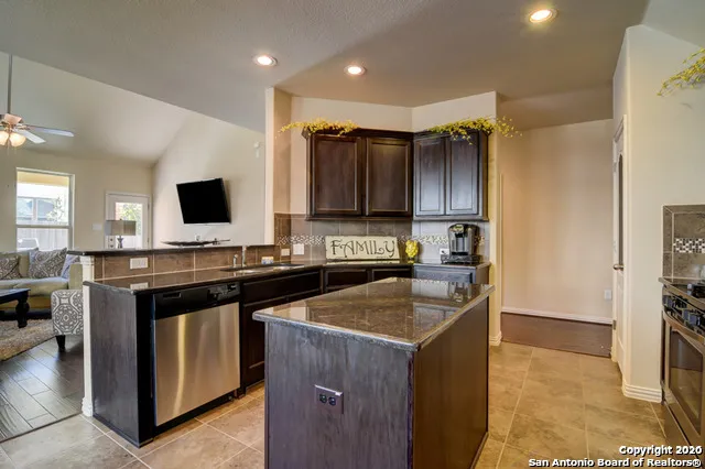 a kitchen that has a sink and a stove in it