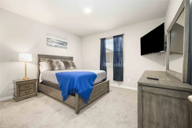a bedroom with a bed and a flat screen television