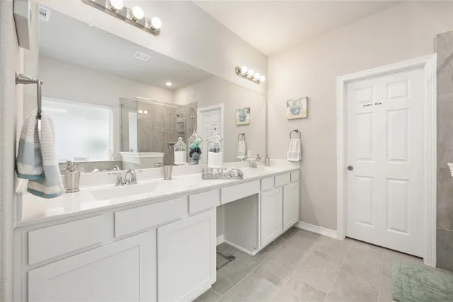 a bathroom with a double vanity sink mirror and