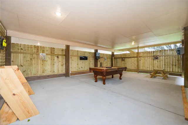 a view of a room with gym equipment and large windows