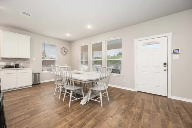 a view of a dining room with furniture and wooden floor