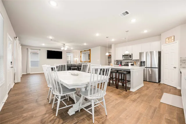 a kitchen with a table and chairs in it