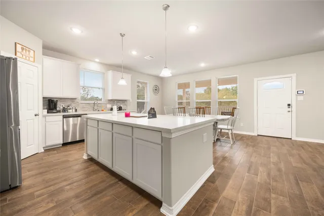 a kitchen with white cabinets and white appliances