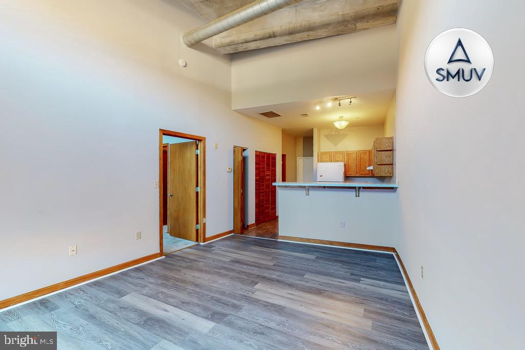 a view of a room with wooden floor and a window