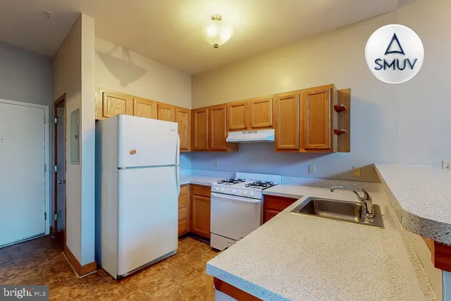 a kitchen with a refrigerator and a sink
