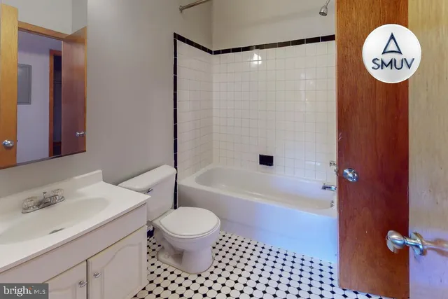 a view of a big room with table and a clock