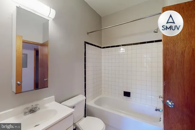 a bathroom with a sink a toilet and a bathtub