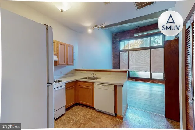 a view of a kitchen with a sink and a window