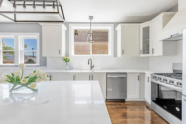 a kitchen with stainless steel appliances a stove a sink and a microwave