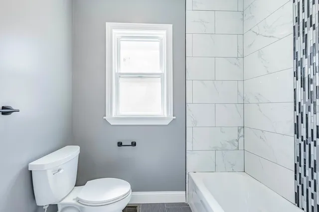 a view of a room with wooden floor and windows