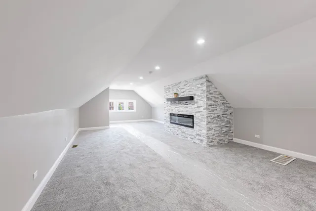 an empty room with a window and a hallway