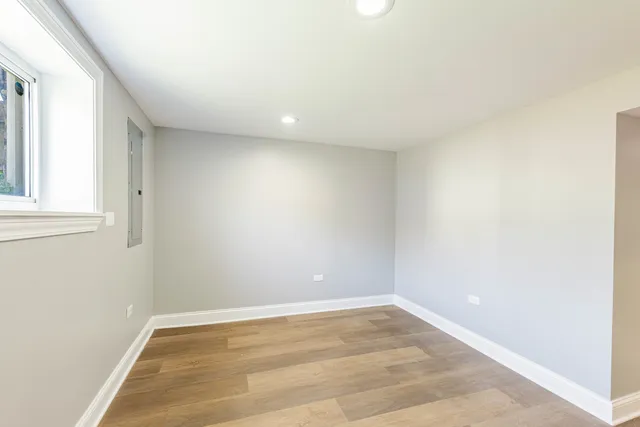 a bathroom with a granite countertop sink toilet and mirror