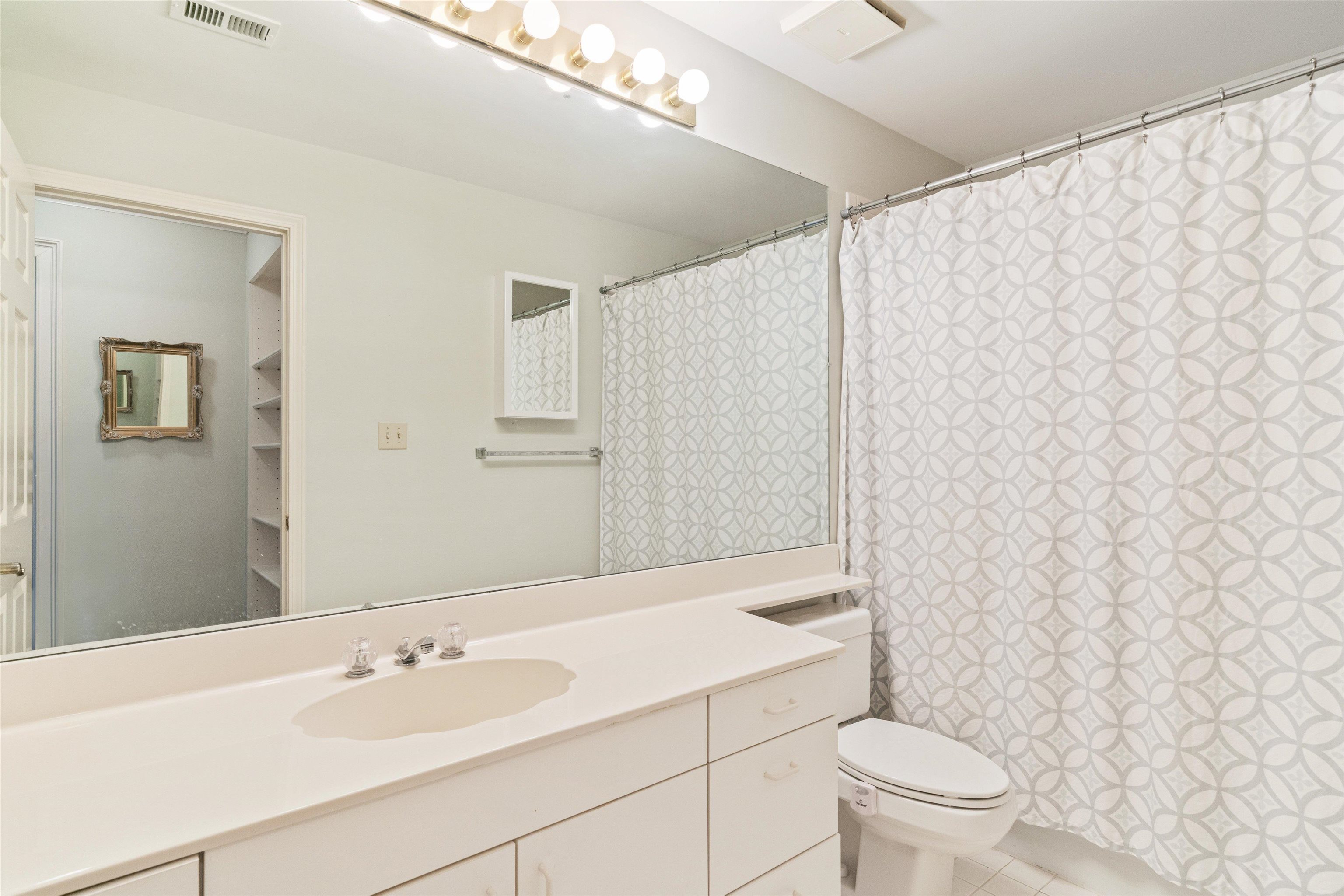 405 South Perkins Road, Unit 250 Memphis, TN 38117 - Photo 5 of 19 a bathroom with a sink mirror and toilet