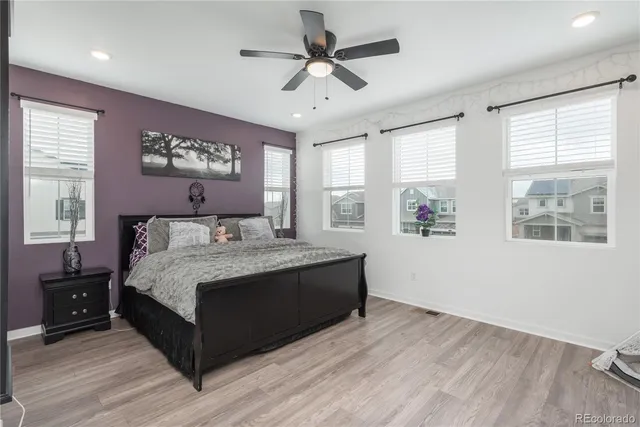 a spacious bedroom with a bed and a window