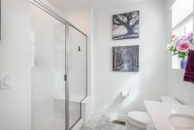 a white toilet sitting next to a bathroom sink