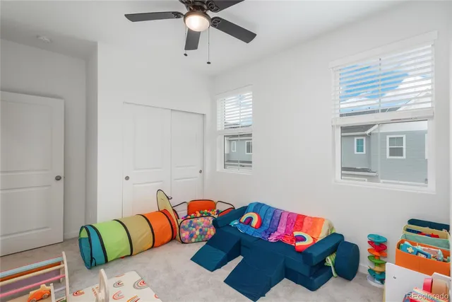 a living room with furniture and a baby crib