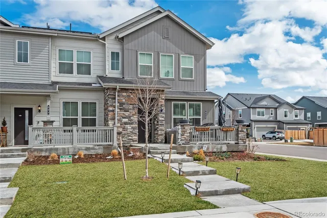 a front view of a house with a yard table and chairs