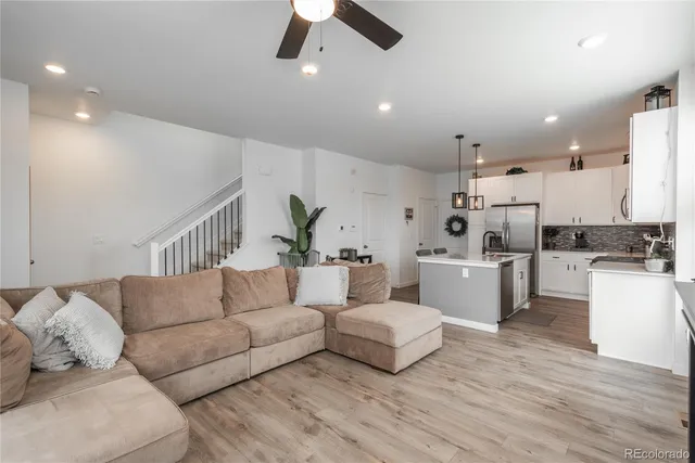 a living room with furniture and kitchen view