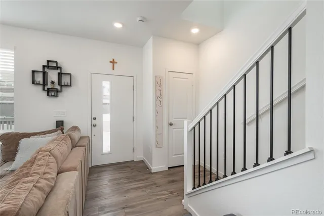 a view of a livingroom with furniture and stairs
