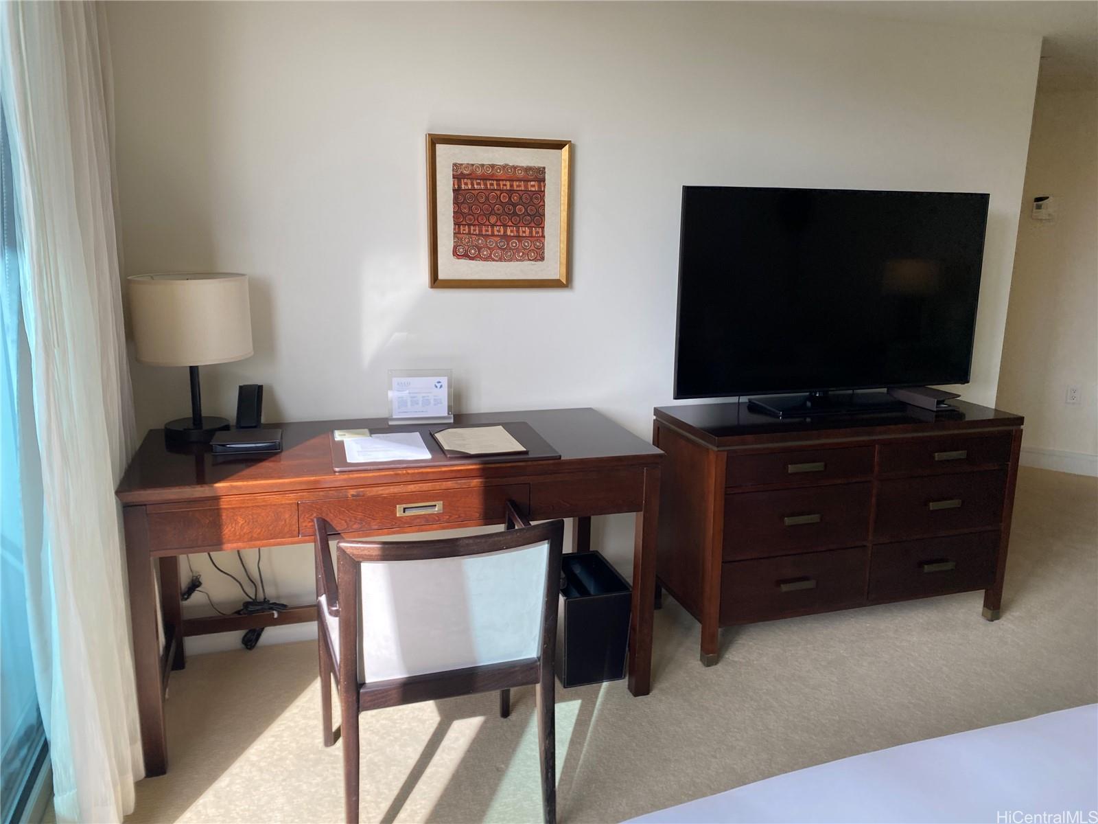 223 Saratoga Road, Unit 2316 Honolulu, HI 96815 - Photo 5 of 20 a living room with furniture and a flat screen tv