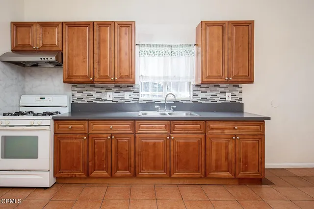 a kitchen with stainless steel appliances granite countertop a sink and cabinets