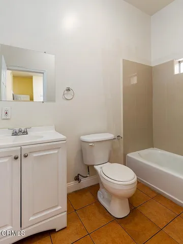 a bathroom with a toilet a sink and a mirror