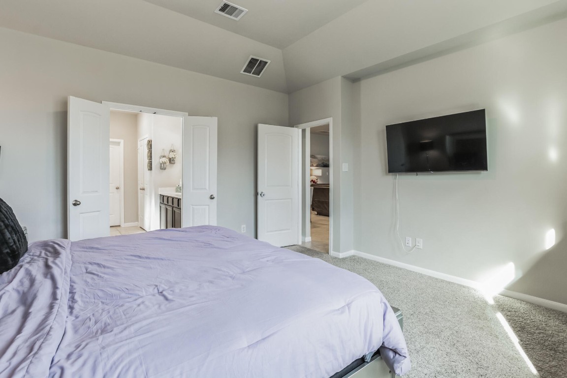 4510 Red Yucca Drive Baytown, TX 77521 - Photo 12 of 29 a bedroom with a bed and a flat screen tv