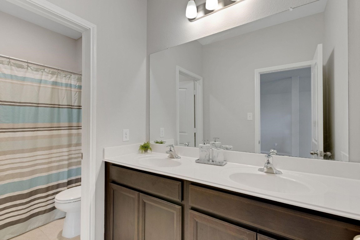 4510 Red Yucca Drive Baytown, TX 77521 - Photo 26 of 29 a bathroom with double vanity sinks and a mirror