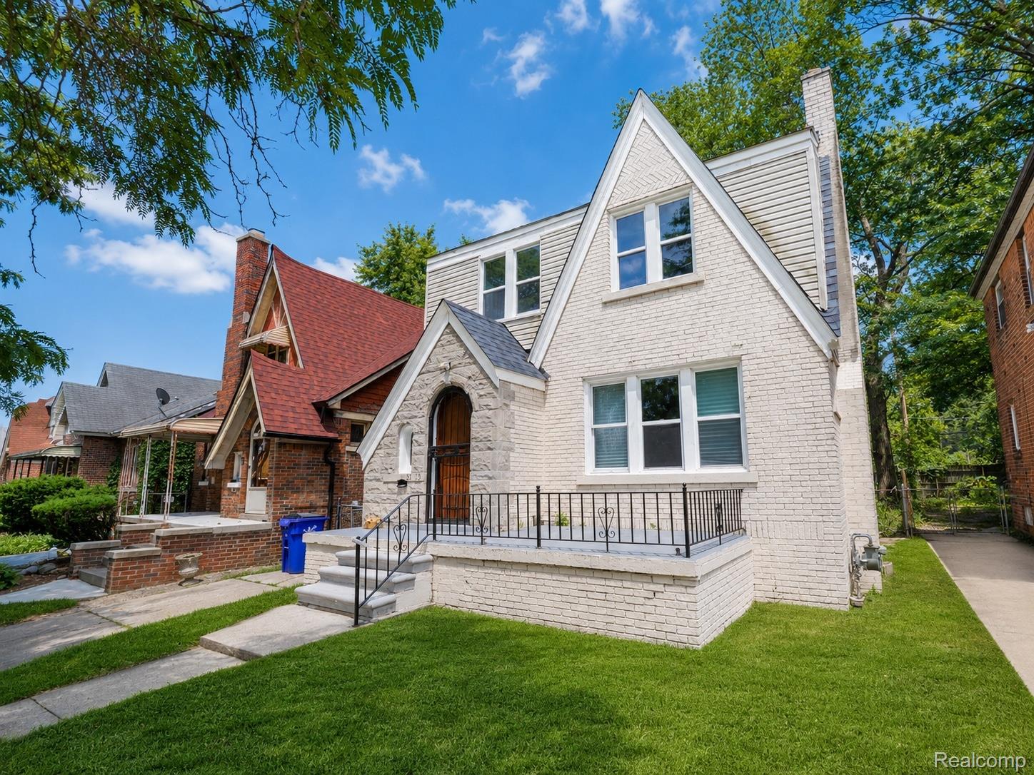 9175 Devonshire Road Detroit, MI 48224 - Photo 1 of 23 Cream-painted brick facade with a stone entryway arch