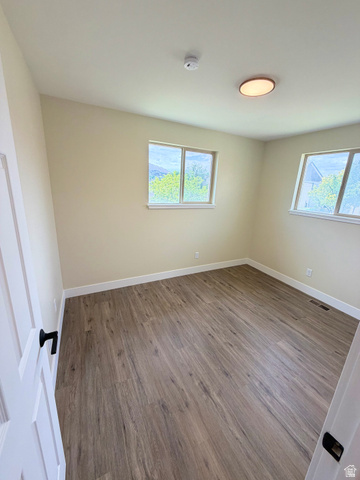 450 13800 South, Unit 2 Draper, UT 84020 - Photo 8 of 21 Room featuring wood-finish flooring, white baseboards, and two windows