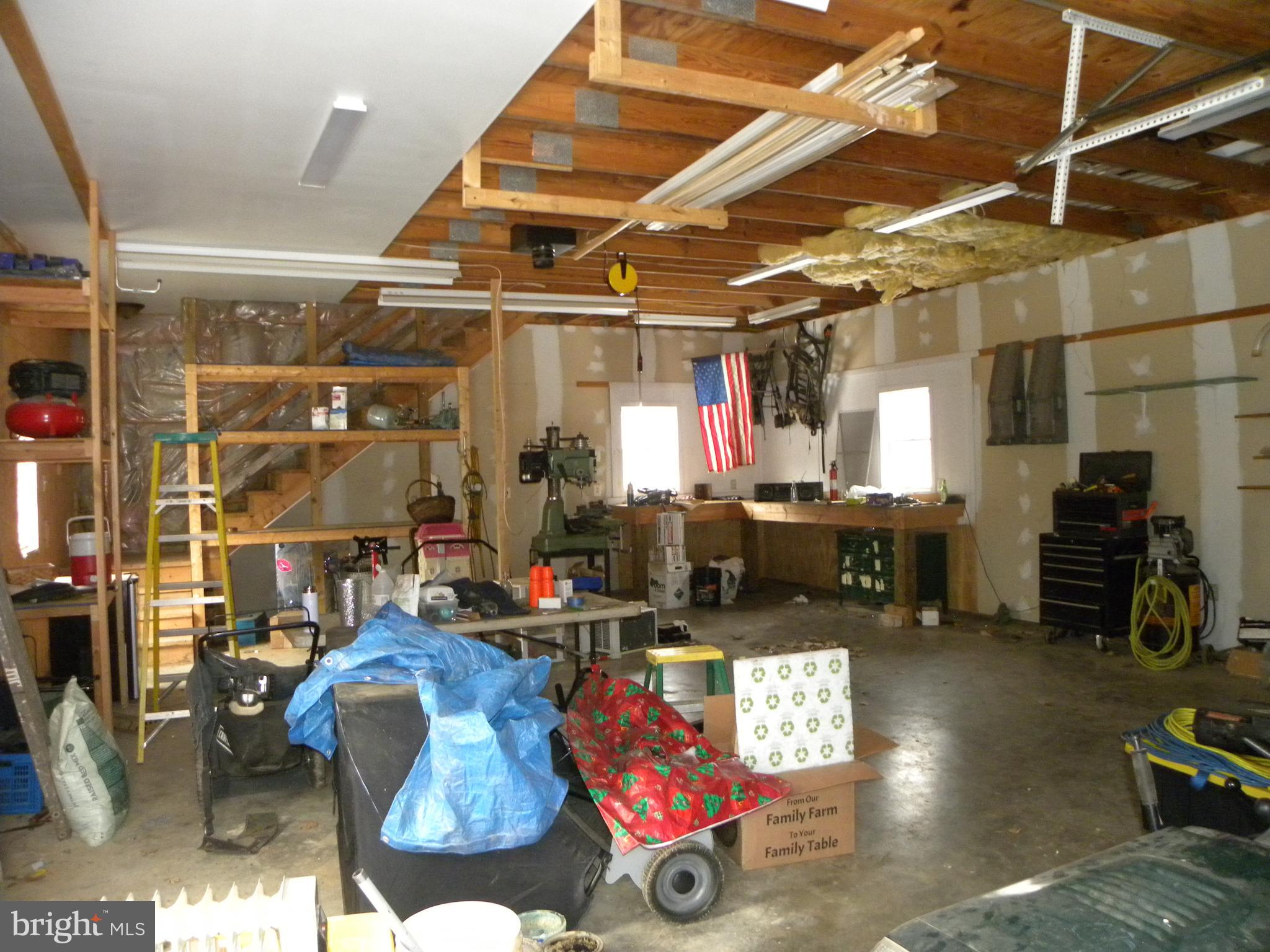 3906 Hooper Road New Windsor, MD 21776 - Photo 11 of 12 Inside of garage with stairs to an upper level