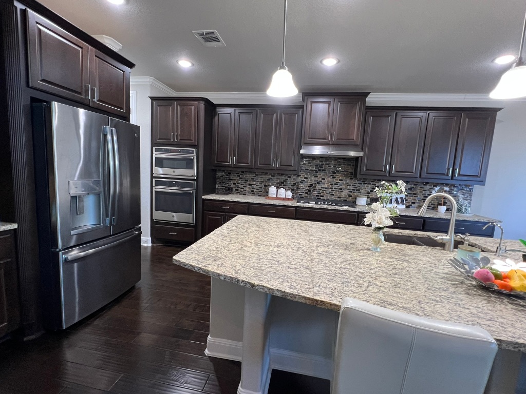 4121 Cappello Way Leander, TX 78641 - Photo 12 of 40 a kitchen with kitchen island a sink appliances and cabinets