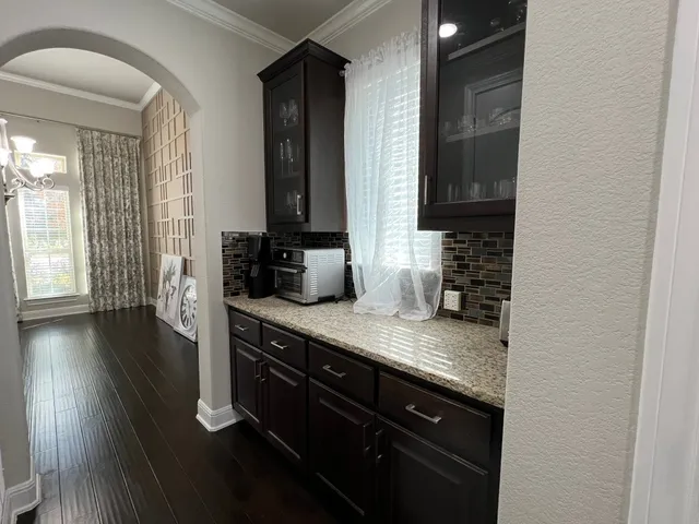 a kitchen with kitchen island wooden floor and stainless steel appliances