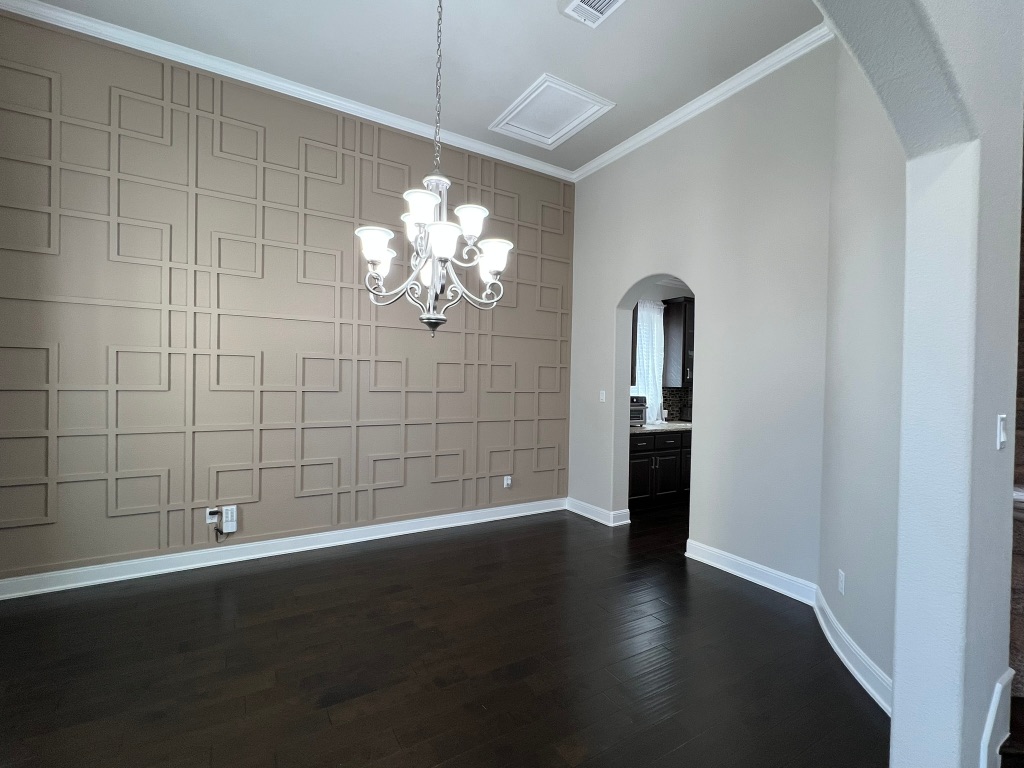 4121 Cappello Way Leander, TX 78641 - Photo 16 of 40 an empty room with wooden floor and chandelier fan