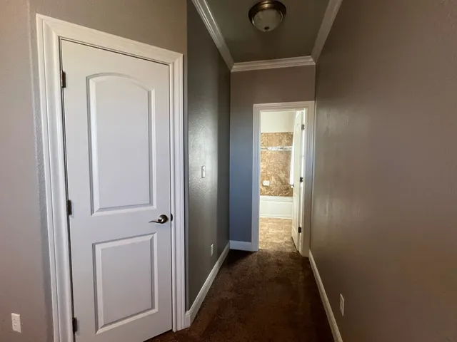 an empty room with closet and a chandelier fan