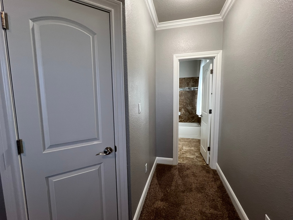 4121 Cappello Way Leander, TX 78641 - Photo 26 of 40 a view of a hallway with a wooden door