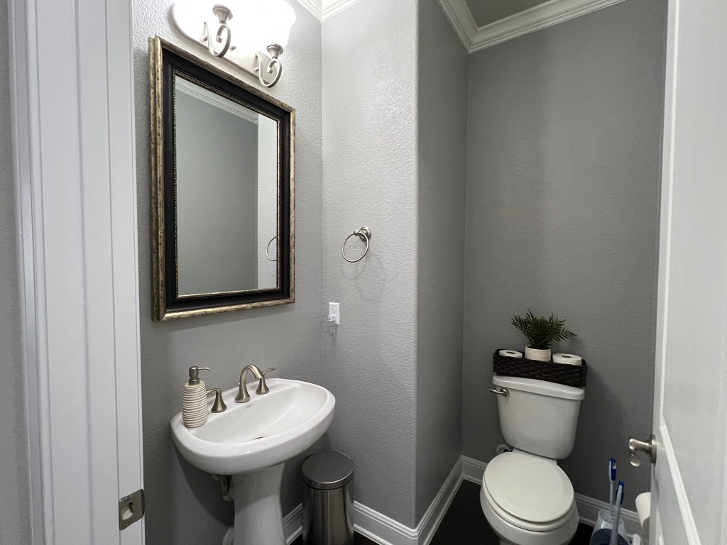 4121 Cappello Way Leander, TX 78641 - Photo 36 of 40 a bathroom with a toilet sink and mirror