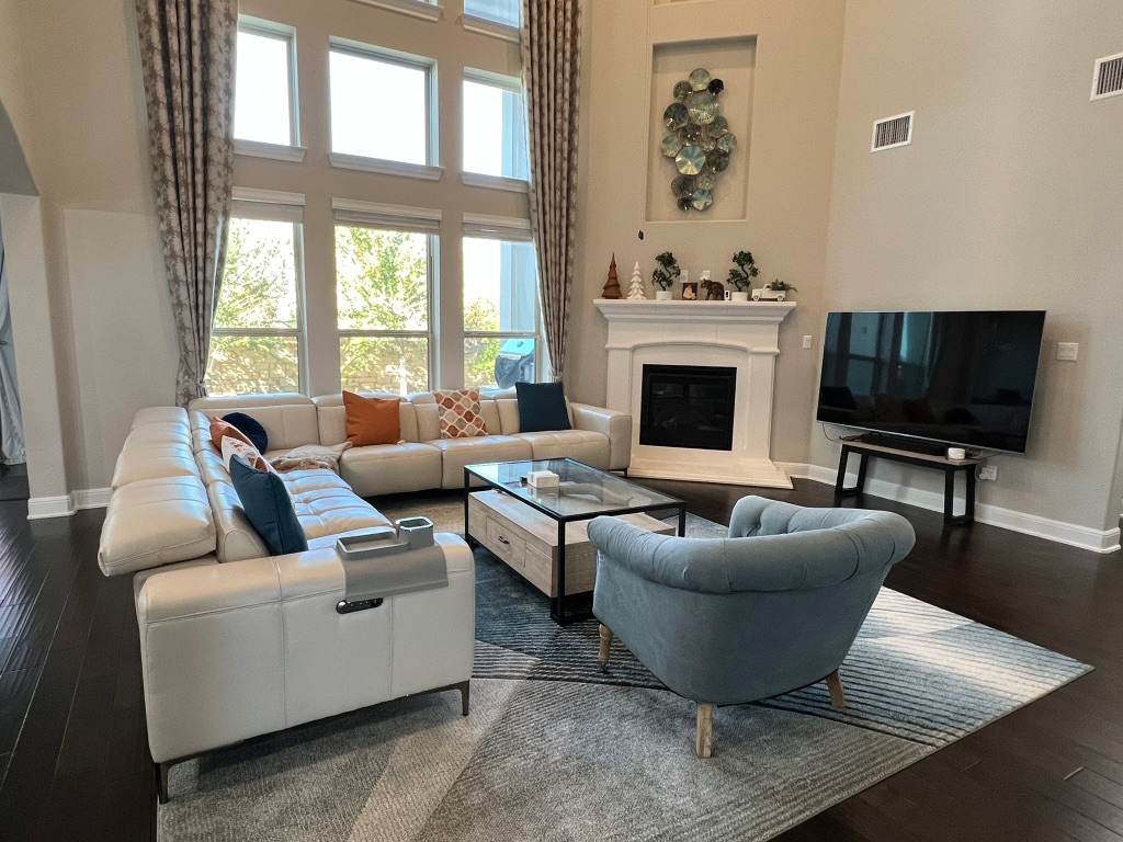 4121 Cappello Way Leander, TX 78641 - Photo 4 of 40 a living room with furniture a fireplace and a flat screen tv